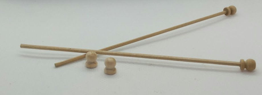 2 curtain poles in miniature and two end knobs on a white background.