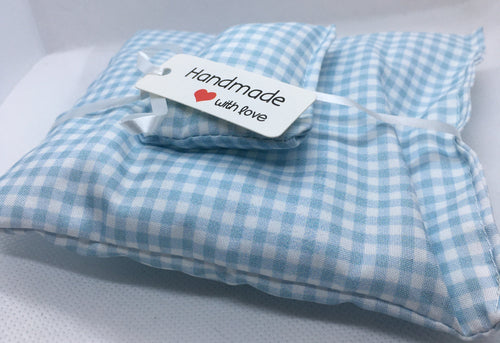 A light blue and white gingham check duvet set in miniature. wrapped with a white ribbon and a white paper tag that reads 'Handmade with love'.