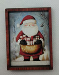 lovely dolls house santa picture carrying his sack of presents hanging on a white background wall.