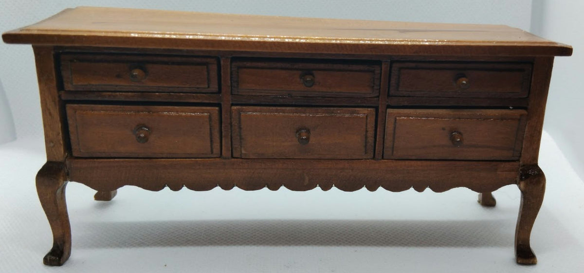 lovely darkwood sideboard with 6 opening drawers on a white background.