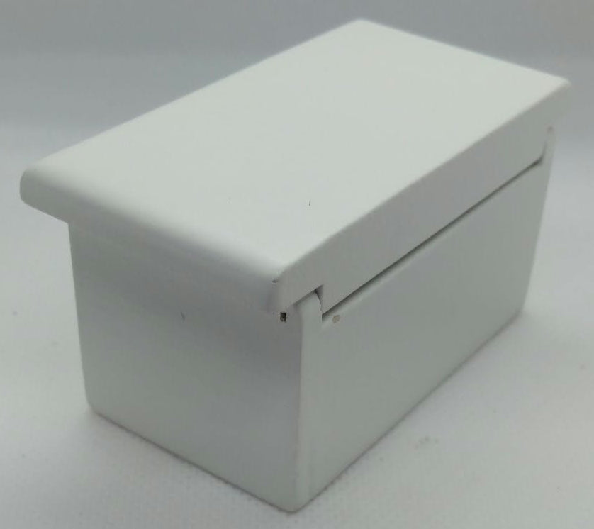 A small white rectangular toy box with a hinged lid, photographed on a plain light gray background.