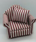 A miniature armchair with red and white vertical stripes, featuring a matching striped cushion, set against a plain light gray background.