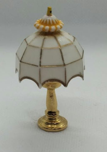 white and brass style miniature lamp on a white background