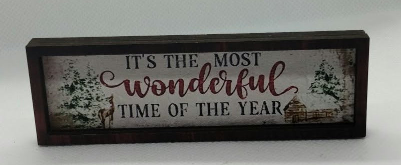 miniature sign for a dolls house in dark wood with "its the most wonderful time of the year " on a white background.